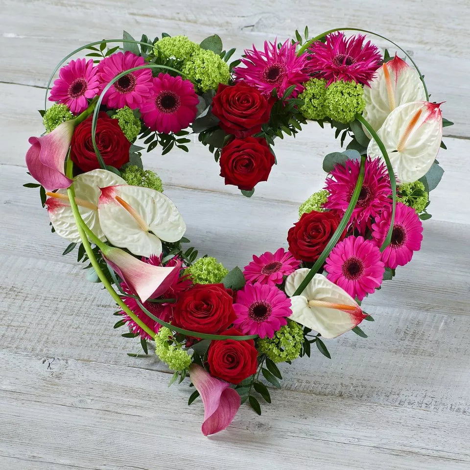 Contemporary open heart funeral tribute with calla lilies and anthuriums