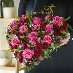Pink and red rose detail of Cerise Rose Heart funeral flowers